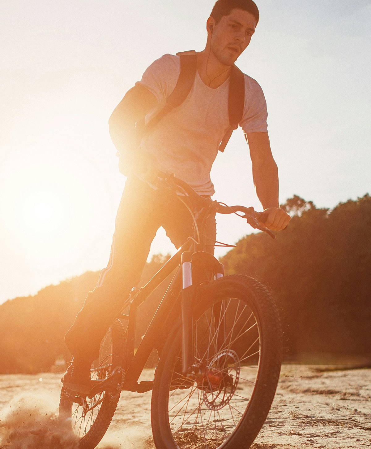Person meditating by the sea at sunset.