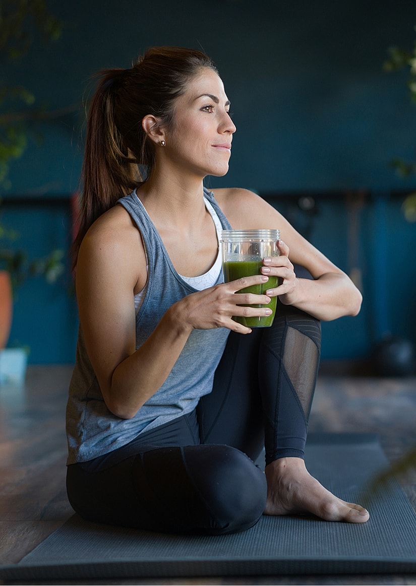 Laboratory technician holding test tubes in rack.