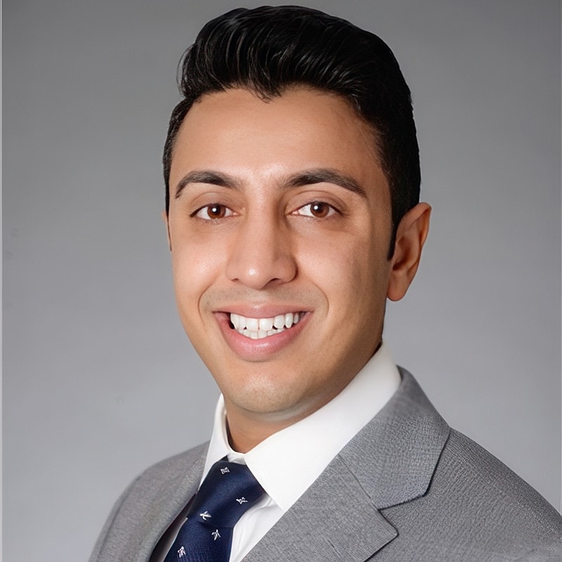 Professional man smiling in suit and tie.