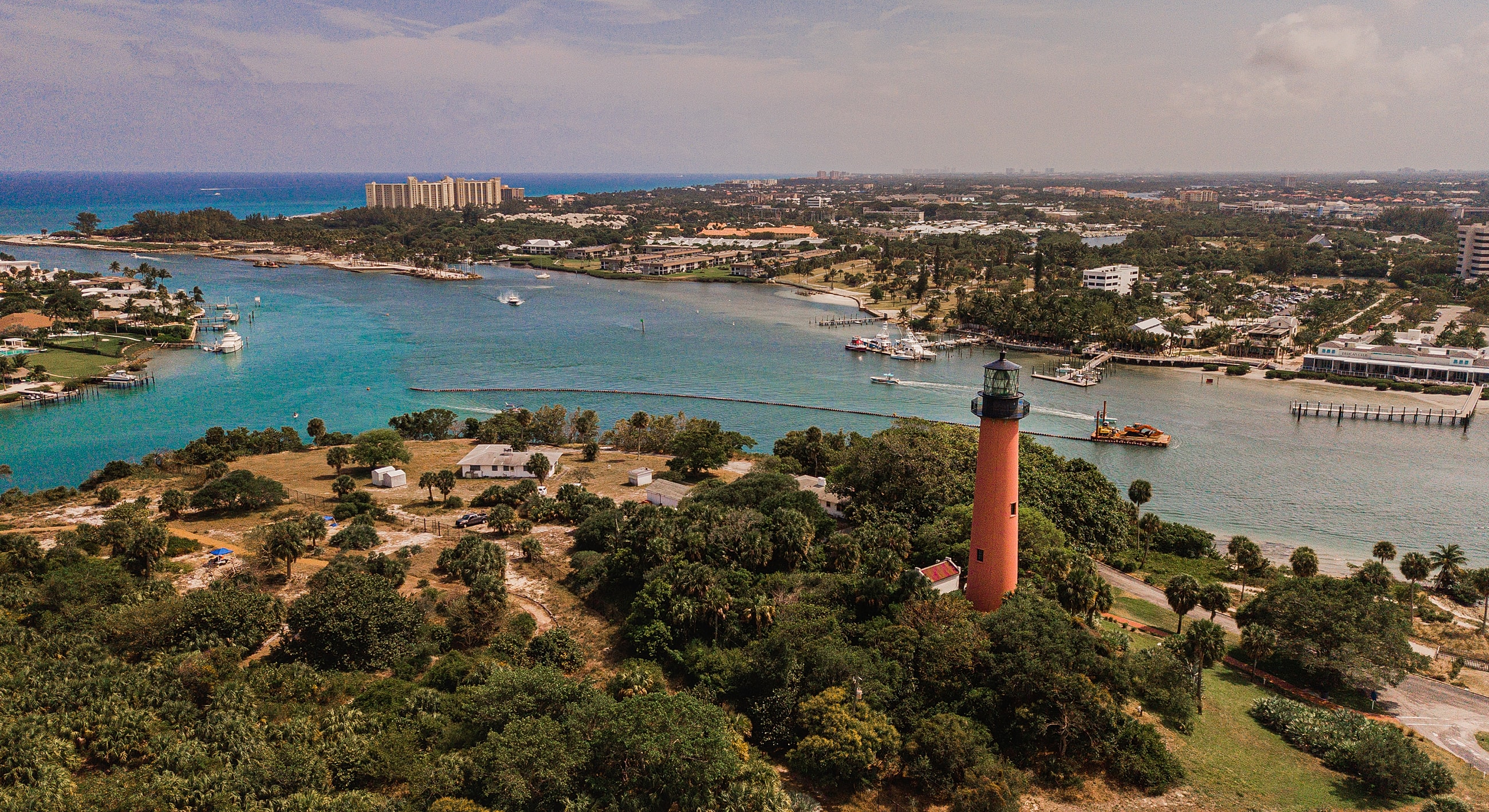 Aerial view of a coastal lighthouse and harbor.